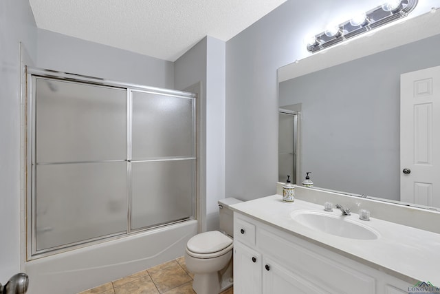 bathroom featuring toilet, enclosed tub / shower combo, tile patterned floors, a textured ceiling, and vanity