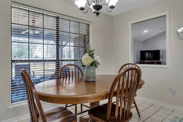 dining area featuring baseboards, light tile patterned flooring, lofted ceiling, and an inviting chandelier