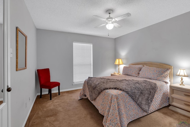 carpeted bedroom featuring a textured ceiling, a ceiling fan, and baseboards