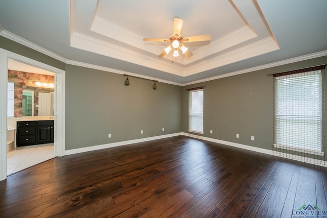 unfurnished room with ceiling fan, a raised ceiling, and ornamental molding