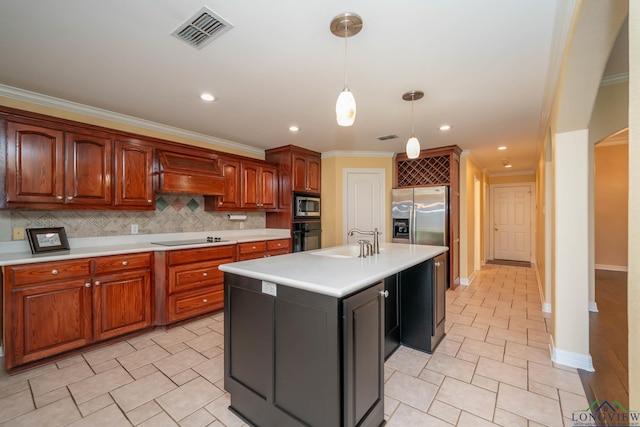 kitchen featuring tasteful backsplash, premium range hood, sink, black appliances, and a center island with sink