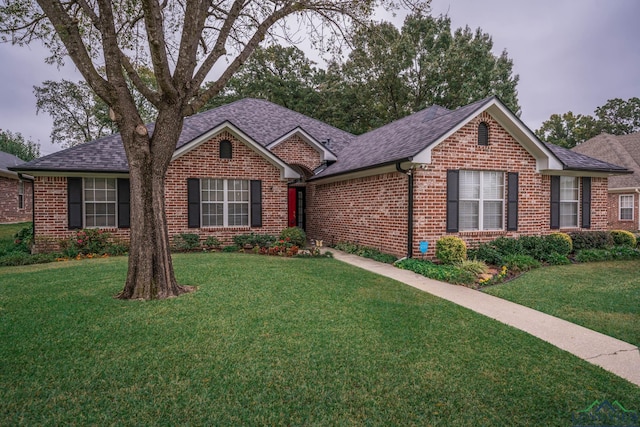 ranch-style home with a front yard