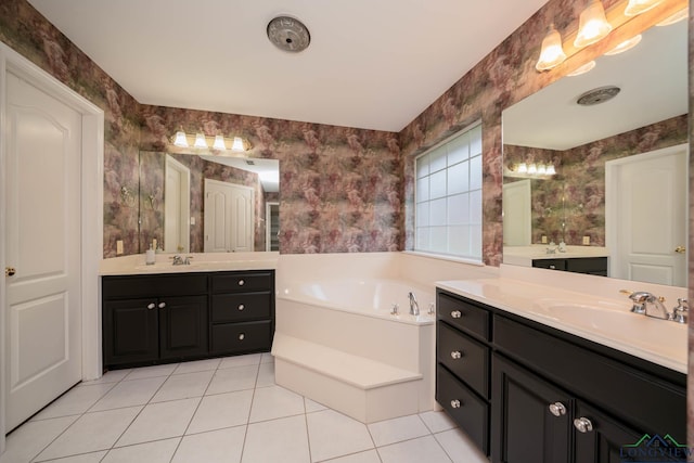 bathroom featuring tile patterned flooring, vanity, and a washtub