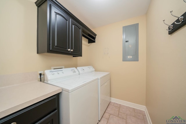 laundry area with light tile patterned flooring, cabinets, electric panel, and washing machine and clothes dryer