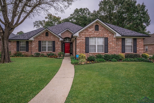 ranch-style home with a front yard