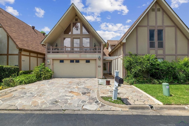 1011 Towne Lake Dr, Longview, TX 75601 - view of front of home featuring stucco siding, a garage, a balcony, and driveway