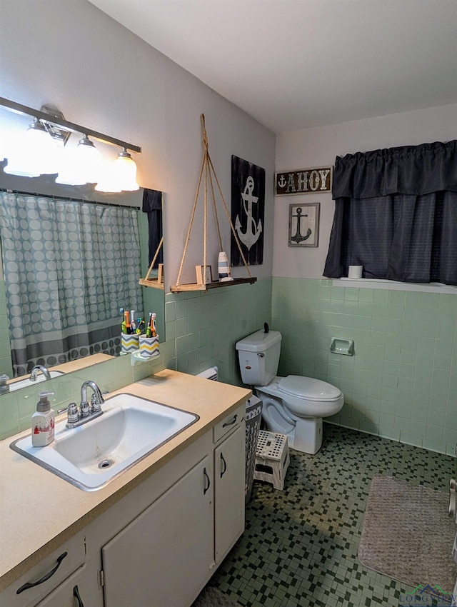 bathroom featuring tile patterned flooring, curtained shower, tile walls, toilet, and vanity