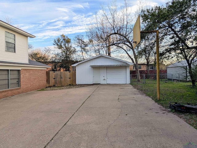 detached garage featuring fence