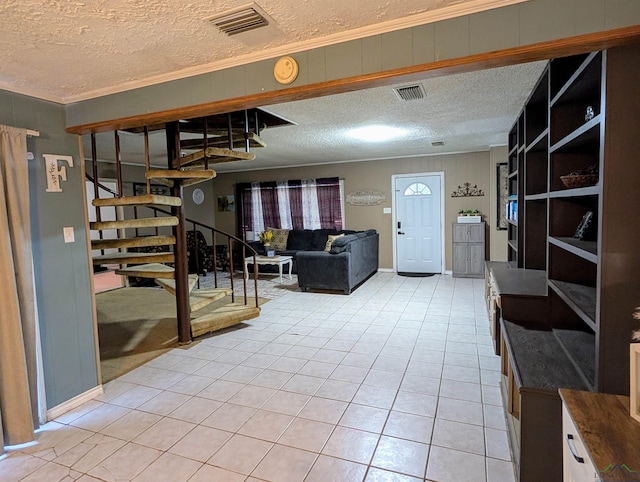 living area featuring light tile patterned flooring, visible vents, stairs, and ornamental molding