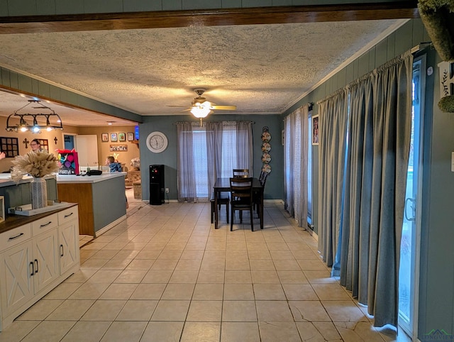 kitchen featuring light tile patterned floors, a ceiling fan, white cabinets, a textured ceiling, and dark countertops