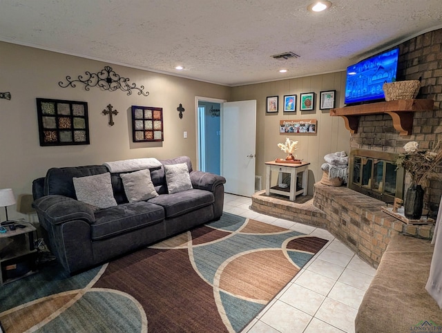 living area featuring visible vents, a brick fireplace, crown molding, tile patterned floors, and a textured ceiling