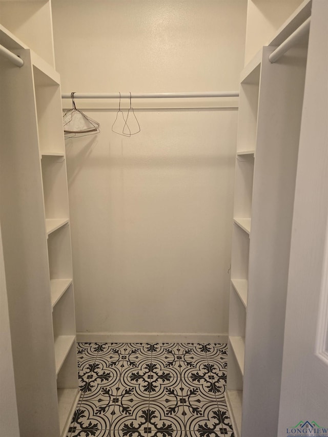 spacious closet featuring light tile patterned flooring