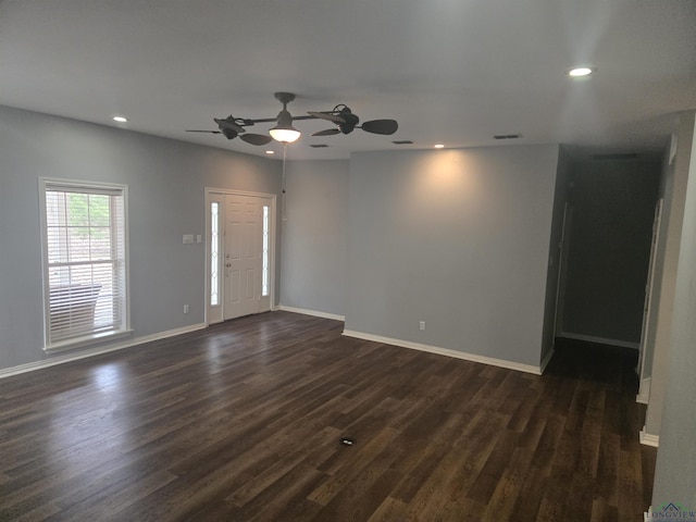 spare room with ceiling fan and dark hardwood / wood-style flooring