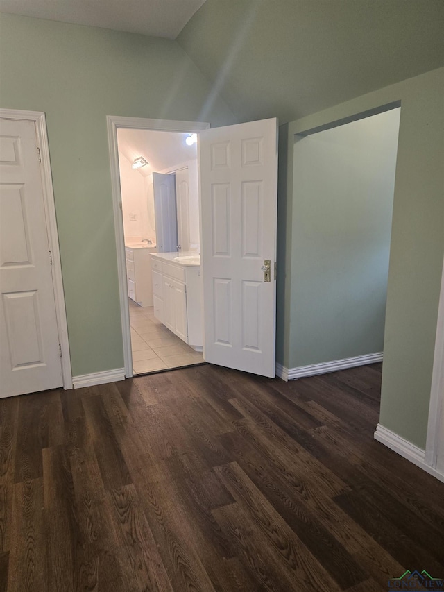 interior space featuring hardwood / wood-style flooring and lofted ceiling