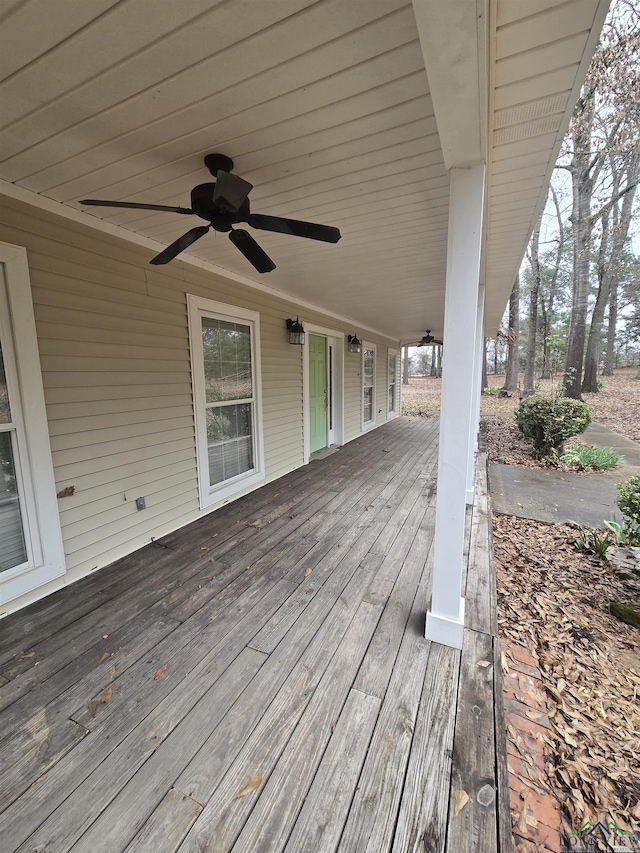 wooden terrace featuring ceiling fan