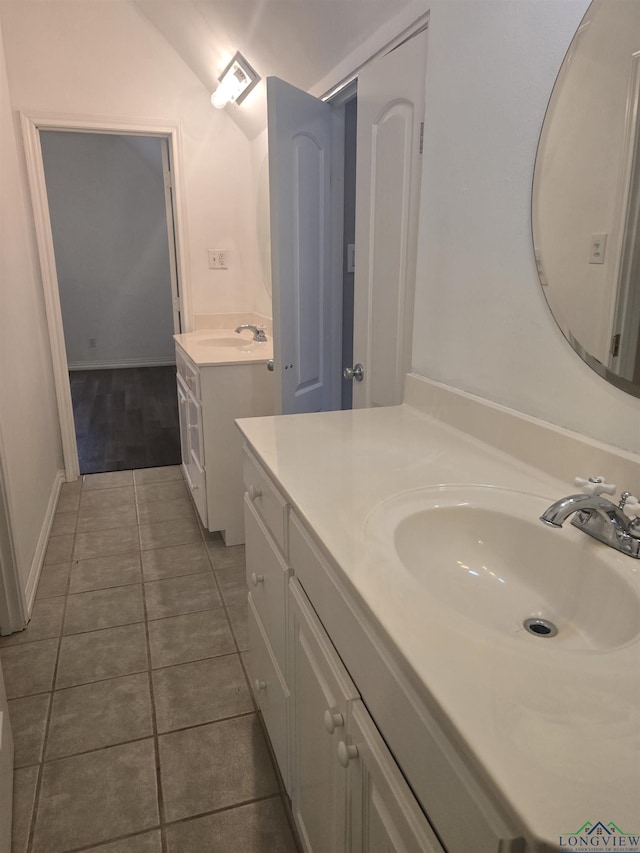 bathroom featuring vanity, vaulted ceiling, and tile patterned floors