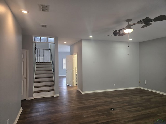 empty room with ceiling fan and dark hardwood / wood-style flooring