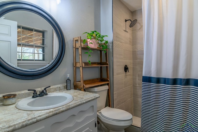 full bath with toilet, a tile shower, and vanity