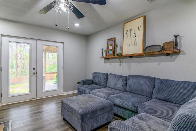 living area with ceiling fan, french doors, and wood finished floors