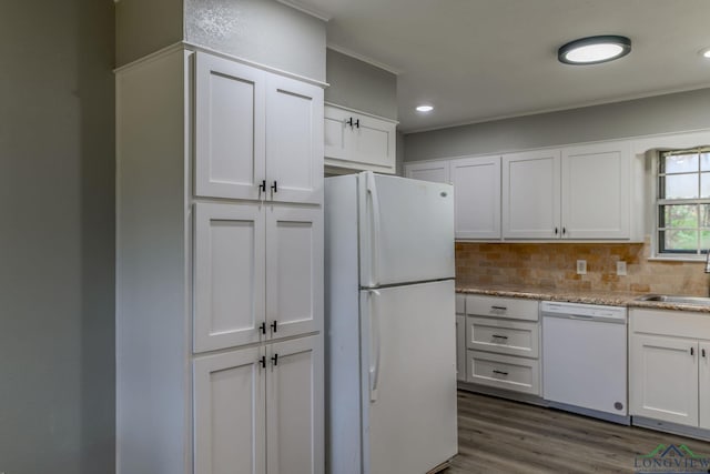 kitchen featuring white appliances, backsplash, and white cabinets