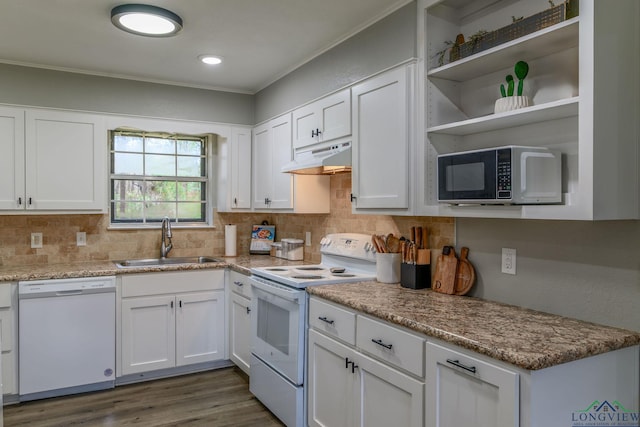 kitchen with white appliances, white cabinetry, a sink, and under cabinet range hood