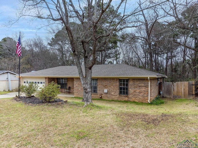 single story home with a garage, brick siding, a front yard, and fence