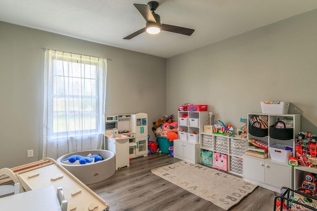 playroom with ceiling fan and wood finished floors