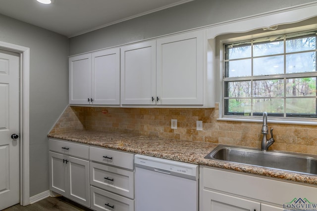 kitchen with white cabinets, dishwasher, backsplash, and a sink