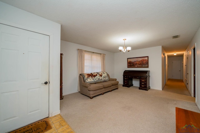 carpeted living room with a chandelier and a textured ceiling