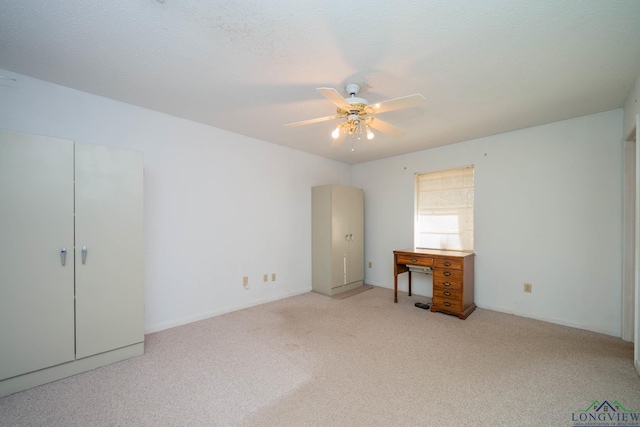 interior space featuring ceiling fan and a textured ceiling