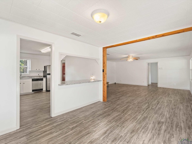 empty room with ceiling fan and wood-type flooring