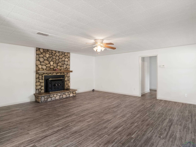 unfurnished living room featuring ceiling fan, a fireplace, and dark hardwood / wood-style flooring