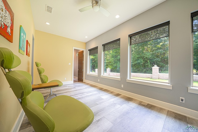 sitting room featuring ceiling fan, a healthy amount of sunlight, and light wood-type flooring