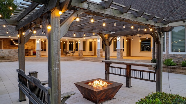 view of patio with a pergola and an outdoor fire pit