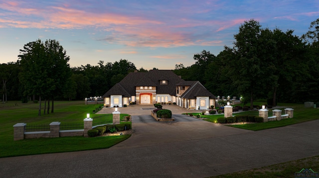 french country style house with a lawn