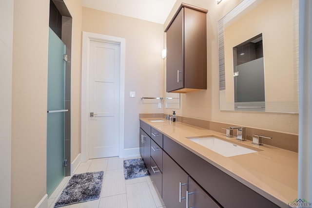 bathroom with a shower with door and vanity