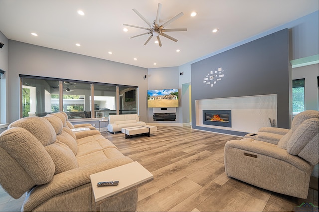 living room with light hardwood / wood-style floors and ceiling fan