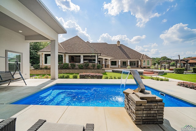 view of pool with pool water feature and a patio