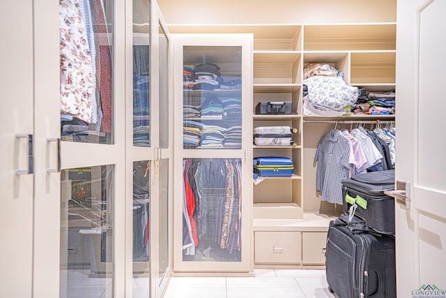 walk in closet featuring light tile patterned flooring