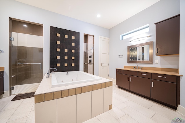 bathroom featuring tile patterned flooring, plus walk in shower, and vanity