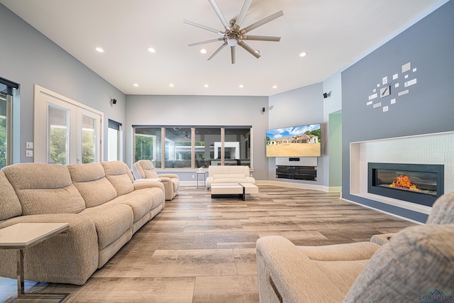 living room with ceiling fan and light hardwood / wood-style floors