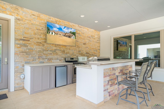 kitchen featuring stainless steel appliances and a kitchen bar