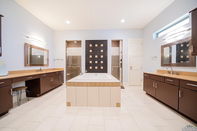 bathroom with independent shower and bath, vanity, and tile patterned floors