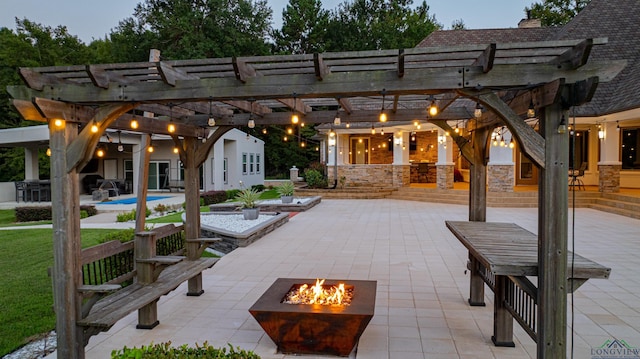 patio terrace at dusk with a pergola and an outdoor fire pit