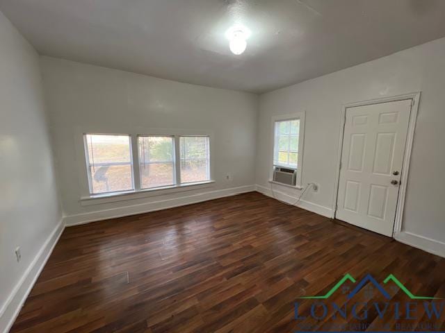 unfurnished room featuring cooling unit and dark wood-type flooring