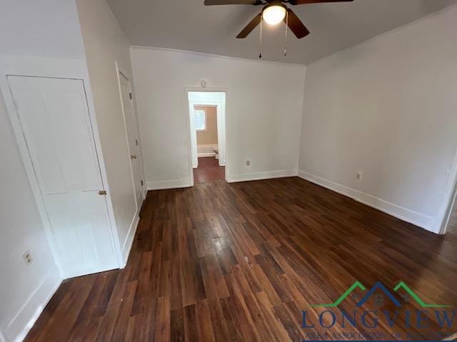 unfurnished bedroom with ceiling fan and dark wood-type flooring