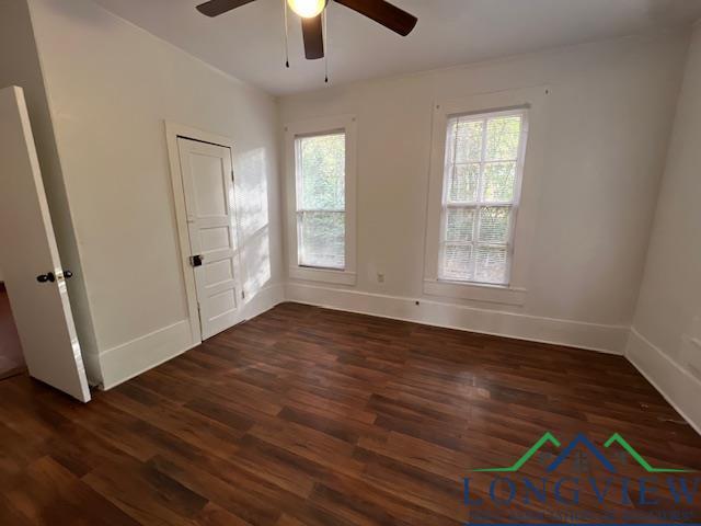 spare room featuring ceiling fan and dark hardwood / wood-style floors