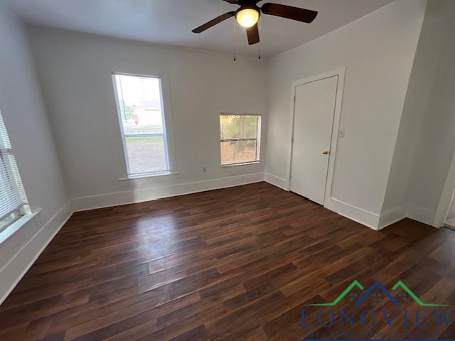 spare room with dark hardwood / wood-style floors and ceiling fan