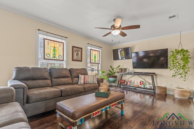 living area with visible vents, ornamental molding, ceiling fan, wood finished floors, and baseboards