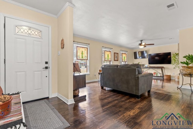 foyer entrance featuring dark wood finished floors, visible vents, crown molding, and baseboards